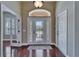 Welcoming foyer with gleaming hardwood floors, decorative glass door, and elegant lighting at 6907 Eagle Ridge Blvd, Lakeland, FL 33813