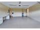 Well-lit garage features a workbench, water heater, and ample space for parking and storage at 6907 Eagle Ridge Blvd, Lakeland, FL 33813