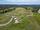 Aerial view of the lush green golf course featuring sand traps and manicured fairways at 6907 Eagle Ridge Blvd, Lakeland, FL 33813