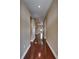 Long hallway with gleaming hardwood floors, neutral walls, and recessed lighting at 6907 Eagle Ridge Blvd, Lakeland, FL 33813