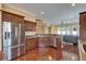 Spacious kitchen features stainless steel appliances, granite countertops, and rich wood cabinets at 6907 Eagle Ridge Blvd, Lakeland, FL 33813