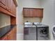 Organized laundry room with modern stainless steel appliances and ample cabinet storage above the counter at 6907 Eagle Ridge Blvd, Lakeland, FL 33813