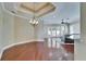 Open living area with hardwood floors, coffered ceiling, elegant chandelier, and access to the outdoors at 6907 Eagle Ridge Blvd, Lakeland, FL 33813