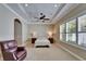 Relaxing main bedroom with a tray ceiling, ceiling fan, and large windows with plantation shutters at 6907 Eagle Ridge Blvd, Lakeland, FL 33813