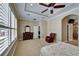 Main bedroom with hardwood floors, a ceiling fan, and large windows for ample natural light at 6907 Eagle Ridge Blvd, Lakeland, FL 33813