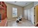Well-lit office space with built-in shelves, stylish chair, and ample natural light from shuttered window at 6907 Eagle Ridge Blvd, Lakeland, FL 33813