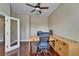 Office features a large desk, ceiling fan, hardwood floors, and natural lighting at 6907 Eagle Ridge Blvd, Lakeland, FL 33813