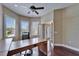 Home office features a desk, a ceiling fan, hardwood floors, and windows at 6907 Eagle Ridge Blvd, Lakeland, FL 33813
