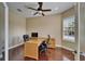 Home office with wood floors, a ceiling fan, a large desk, and a window at 6907 Eagle Ridge Blvd, Lakeland, FL 33813