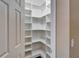 Walk-in pantry featuring ample shelving for organized storage at 6907 Eagle Ridge Blvd, Lakeland, FL 33813