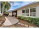 A stone patio is adjacent to a screened in lanai with white plantation shutters on the windows at 6907 Eagle Ridge Blvd, Lakeland, FL 33813