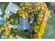 Aerial view of the property highlighting the home's layout, landscaping, and outdoor living spaces surrounded by trees at 7010 Parliament Pl, Lakeland, FL 33809
