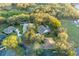 Aerial view of the home and neighborhood showcasing the well-maintained landscaping and proximity to nearby homes at 7010 Parliament Pl, Lakeland, FL 33809