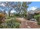 Lush backyard showcasing a variety of plants, patio space, and serene outdoor setting at 7010 Parliament Pl, Lakeland, FL 33809