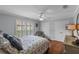 Bright bedroom featuring a ceiling fan, shutters, and closet space at 7010 Parliament Pl, Lakeland, FL 33809