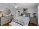 Comfortable bedroom with hardwood floors, ceiling fan, and dresser at 7010 Parliament Pl, Lakeland, FL 33809