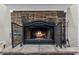 Living room fireplace boasting a decorative iron screen and a stone hearth, adding warmth and character at 7010 Parliament Pl, Lakeland, FL 33809