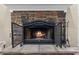 Stone fireplace with a decorative metal screen, creating a cozy and inviting ambiance in the home at 7010 Parliament Pl, Lakeland, FL 33809