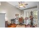 Well-lit home office with hardwood floors, shuttered windows, and ample desk space at 7010 Parliament Pl, Lakeland, FL 33809