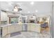 Open-concept kitchen with granite countertops, stainless steel appliances, and a view to the living room at 7010 Parliament Pl, Lakeland, FL 33809