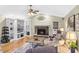 Spacious living room boasts a stone fireplace, built-in shelving, and hardwood floors at 7010 Parliament Pl, Lakeland, FL 33809