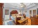 Beautiful main bedroom with a tray ceiling, hardwood floors, and stylish decor at 7010 Parliament Pl, Lakeland, FL 33809