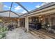 Inviting outdoor bar area with stone accents, seating, and a grill for entertaining at 7010 Parliament Pl, Lakeland, FL 33809