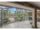 Screened porch with brick flooring, barbecue, and a view of the landscaped backyard at 7010 Parliament Pl, Lakeland, FL 33809