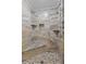 Elegant walk-in shower with stone walls, built-in shelving, and pebble flooring at 7010 Parliament Pl, Lakeland, FL 33809