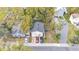 A birds eye view of the property including the roof, trees and the driveway with parked cars at 723 W Patterson St, Lakeland, FL 33803