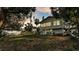 Expansive backyard featuring a covered porch, mature trees, and an inviting fire pit at 723 W Patterson St, Lakeland, FL 33803