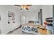 Well-lit bedroom with ceiling fan, carpeted floor, and built-in shelving offer ample space at 723 W Patterson St, Lakeland, FL 33803