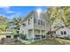 Charming two-story home featuring a covered porch, a fenced yard, and a well maintained green lawn at 723 W Patterson St, Lakeland, FL 33803