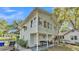 Charming home with a covered porch, a fenced yard, and a well maintained green lawn at 723 W Patterson St, Lakeland, FL 33803