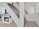 Carpeted staircase with modern railing, adjacent to the electric fireplace and television set at 723 W Patterson St, Lakeland, FL 33803
