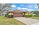 Charming single-story home featuring a brick-accented facade and a well-maintained lawn with mature landscaping at 7639 Lewis Rd, Lakeland, FL 33810