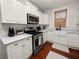 Bright kitchen featuring white cabinets, stainless steel appliances, and a farmhouse sink at 805 Johnson Ave, Lakeland, FL 33801