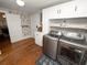 Laundry room featuring a modern washer and dryer with white cabinets and shelving at 805 Johnson Ave, Lakeland, FL 33801