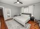 Cozy main bedroom featuring a ceiling fan, bedside tables and lamps, and a large area rug at 805 Johnson Ave, Lakeland, FL 33801