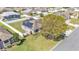 Expansive aerial view of the home featuring lush lawn, solar panels, and fenced yard at 8158 Woodvine Cir, Lakeland, FL 33810