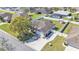 Aerial view of a home showcasing a fenced yard, screened-in patio, lush landscaping and driveway at 8158 Woodvine Cir, Lakeland, FL 33810