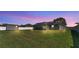 Expansive backyard featuring a screened-in patio, storage shed, and lush green grass at 8158 Woodvine Cir, Lakeland, FL 33810