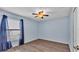 Comfortable bedroom featuring light blue walls, wood-look floors, and a ceiling fan at 8158 Woodvine Cir, Lakeland, FL 33810