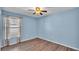 This bedroom features wood-look flooring and a window with blinds at 8158 Woodvine Cir, Lakeland, FL 33810