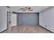 Spacious bedroom featuring modern ceiling fan, two toned walls and wood laminate flooring at 8158 Woodvine Cir, Lakeland, FL 33810