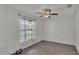 Well-lit bedroom with a large window, ceiling fan, and neutral walls creating a peaceful atmosphere at 8158 Woodvine Cir, Lakeland, FL 33810
