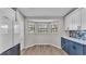 Bright breakfast nook with bay windows, wood-look floors, blue cabinets, and white accents at 8158 Woodvine Cir, Lakeland, FL 33810