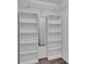 Walk-in closet boasting custom shelves, closet rod, and neutral gray wall paint at 8158 Woodvine Cir, Lakeland, FL 33810
