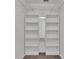 Walk-in closet boasting custom shelves, closet rod, and neutral gray wall paint at 8158 Woodvine Cir, Lakeland, FL 33810