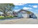 Driveway leading to a two-car garage, showcasing the home's exterior and landscaping at 8158 Woodvine Cir, Lakeland, FL 33810
